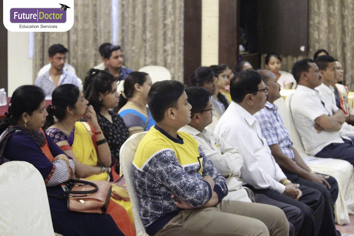 Students and parents attending and listening to the get together