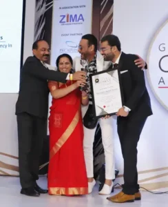 Dr. Amit Borade receiving the Most Trusted Educational Consultancy - 2019 award from Jackie Shroff