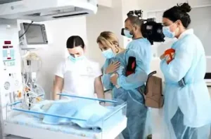 Engaged students attentively participating in a practical lesson led by a teacher at Tbilisi State Medical University